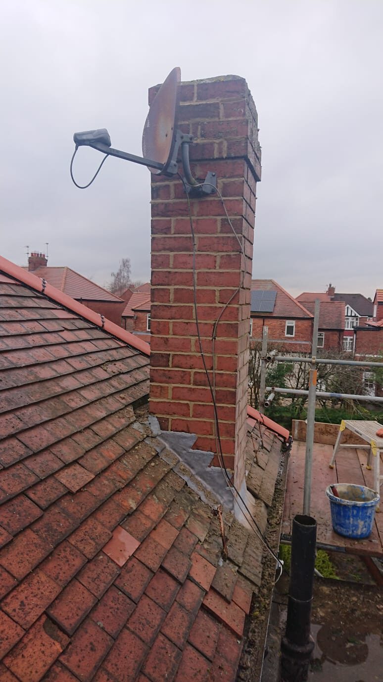 Chimney repair work on a UK rooftop