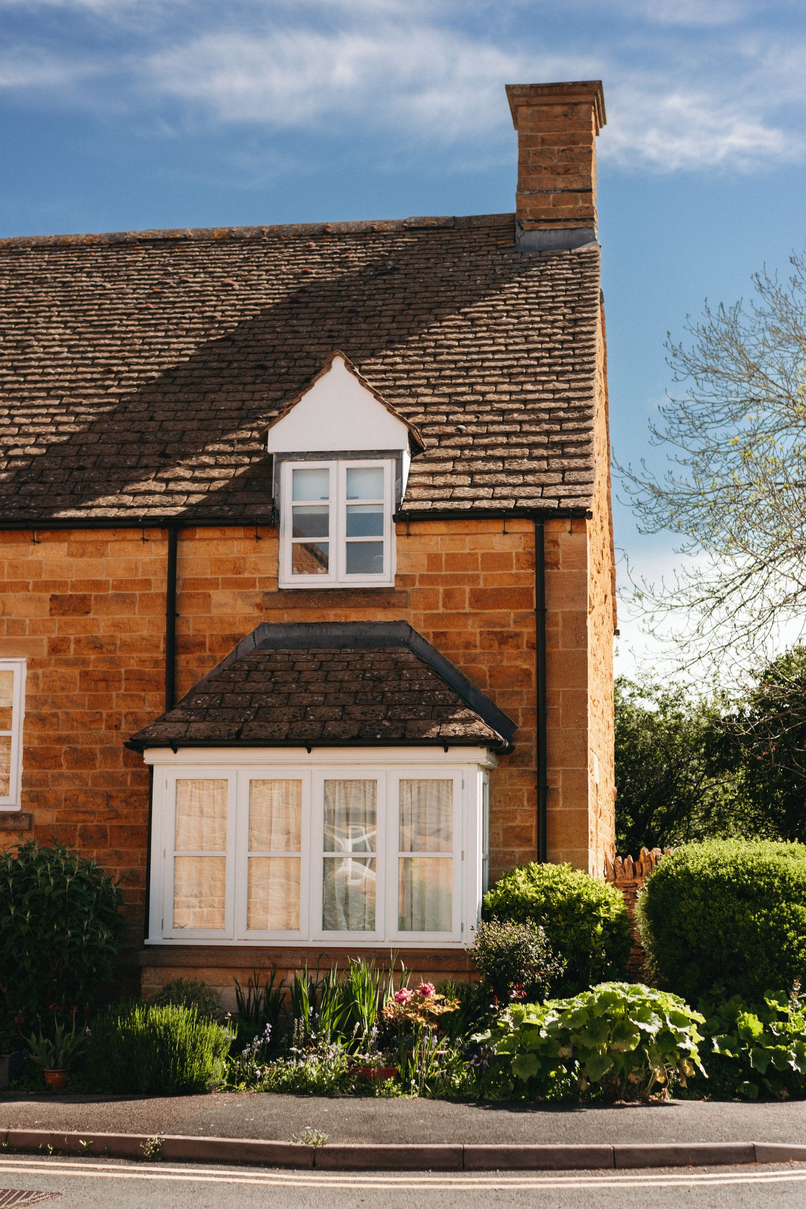 Traditional British stone house with dormer roof